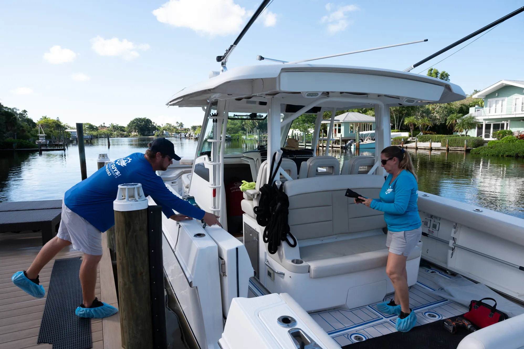 Boat Guys technicians boarding a boat to detail it