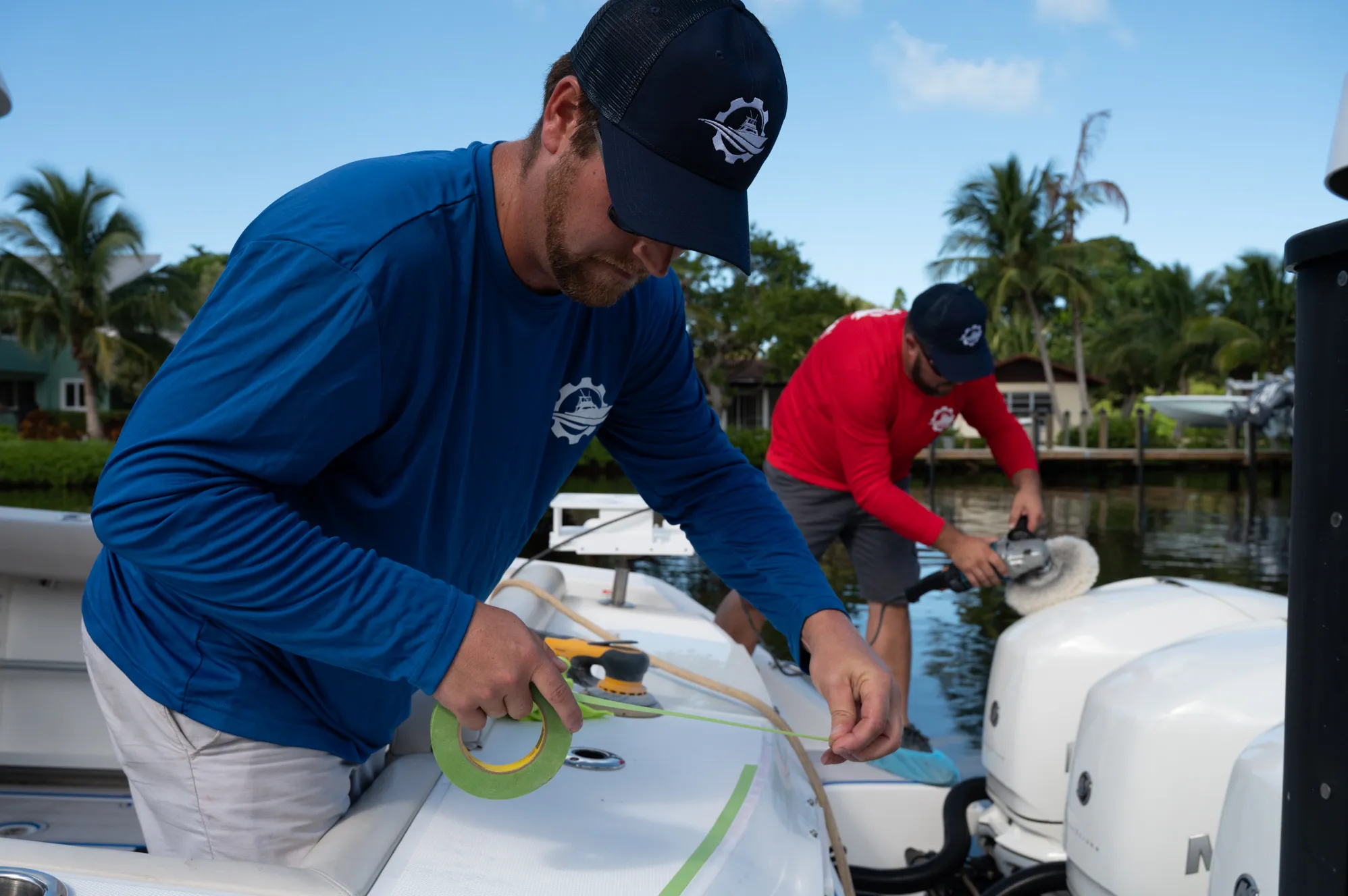Masking and prepping a boat near the outboards