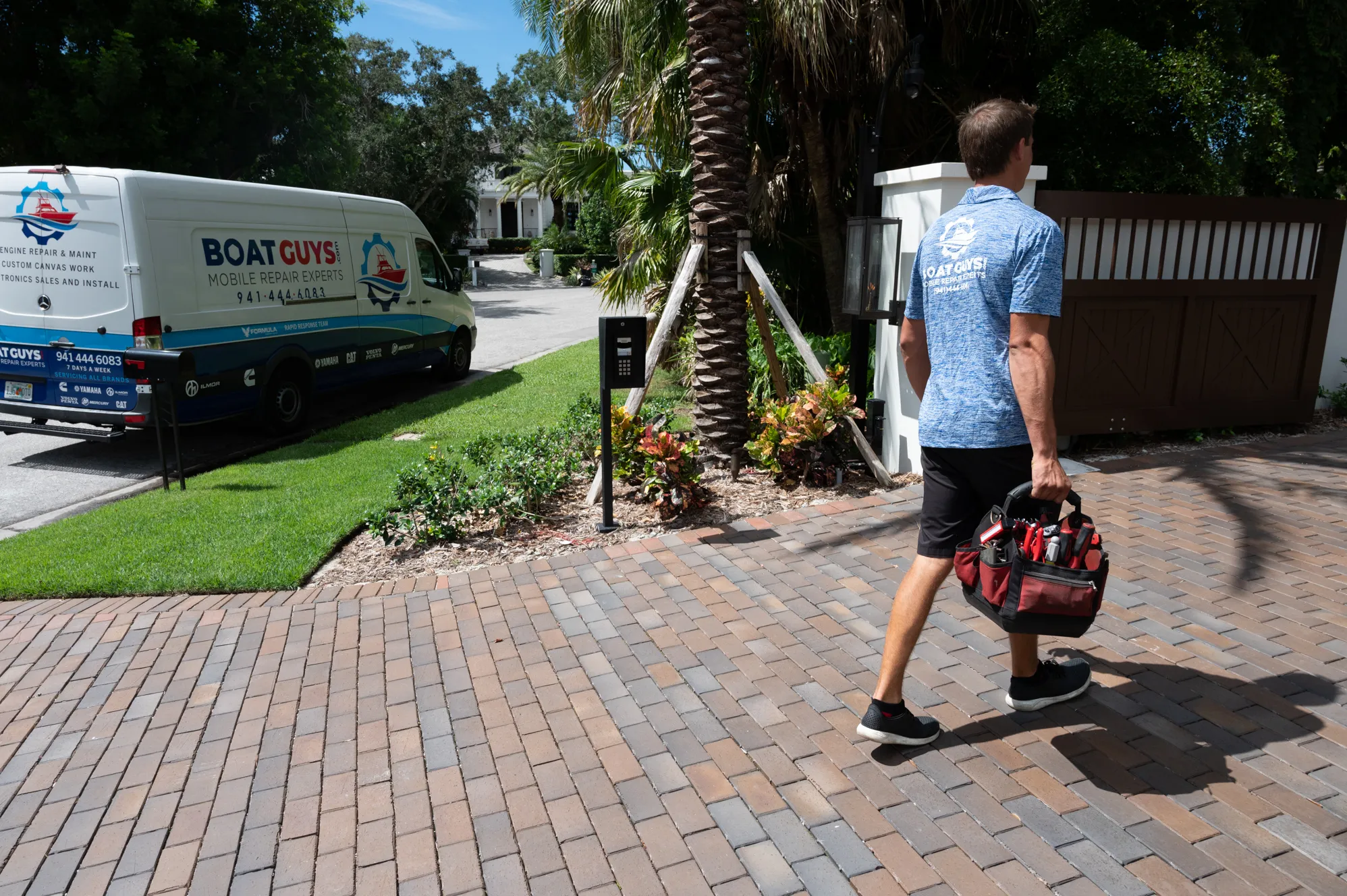 Boat Guys technician carrying a tool bag to the mobile repair van