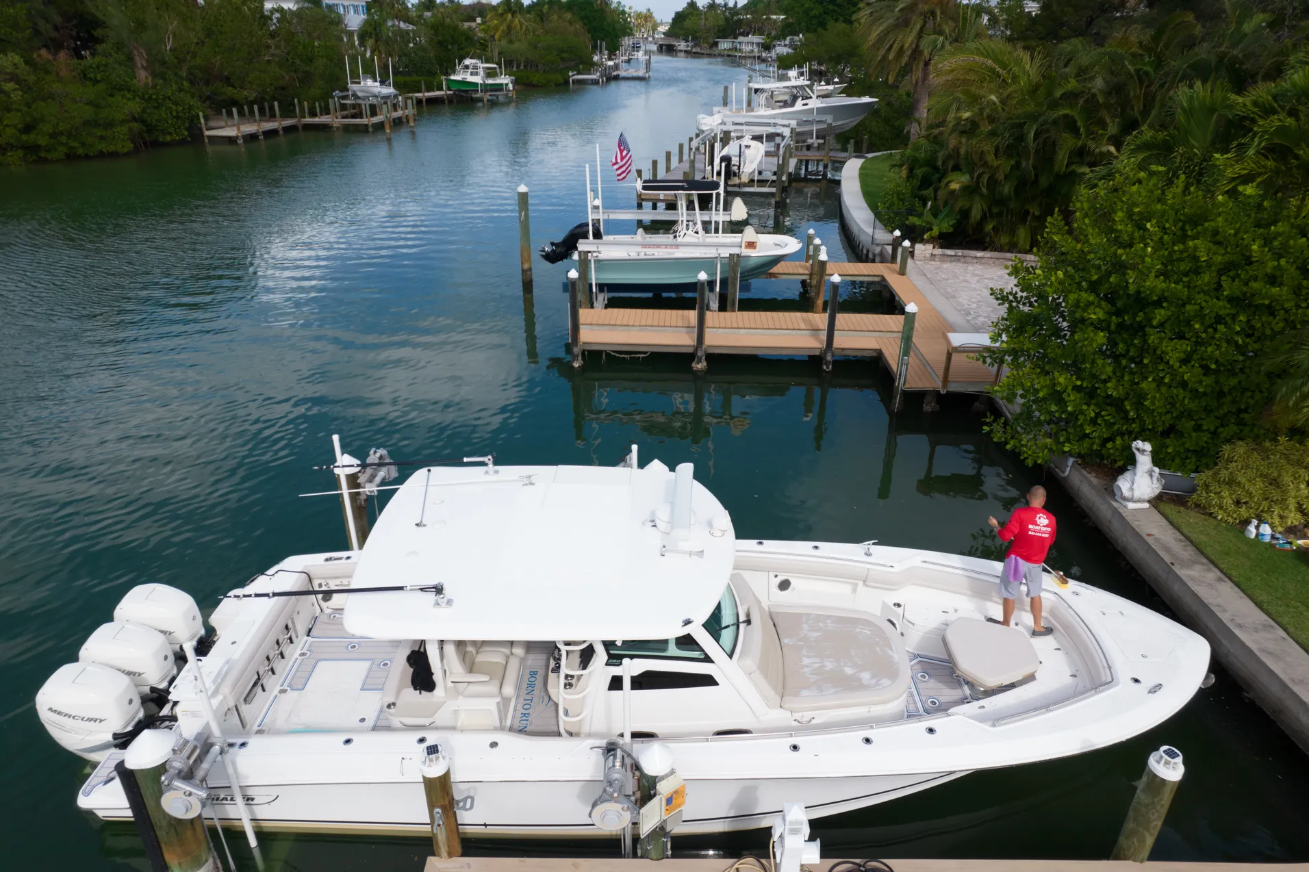 A Boat Guys technician servicing a boat at the owner's dock
