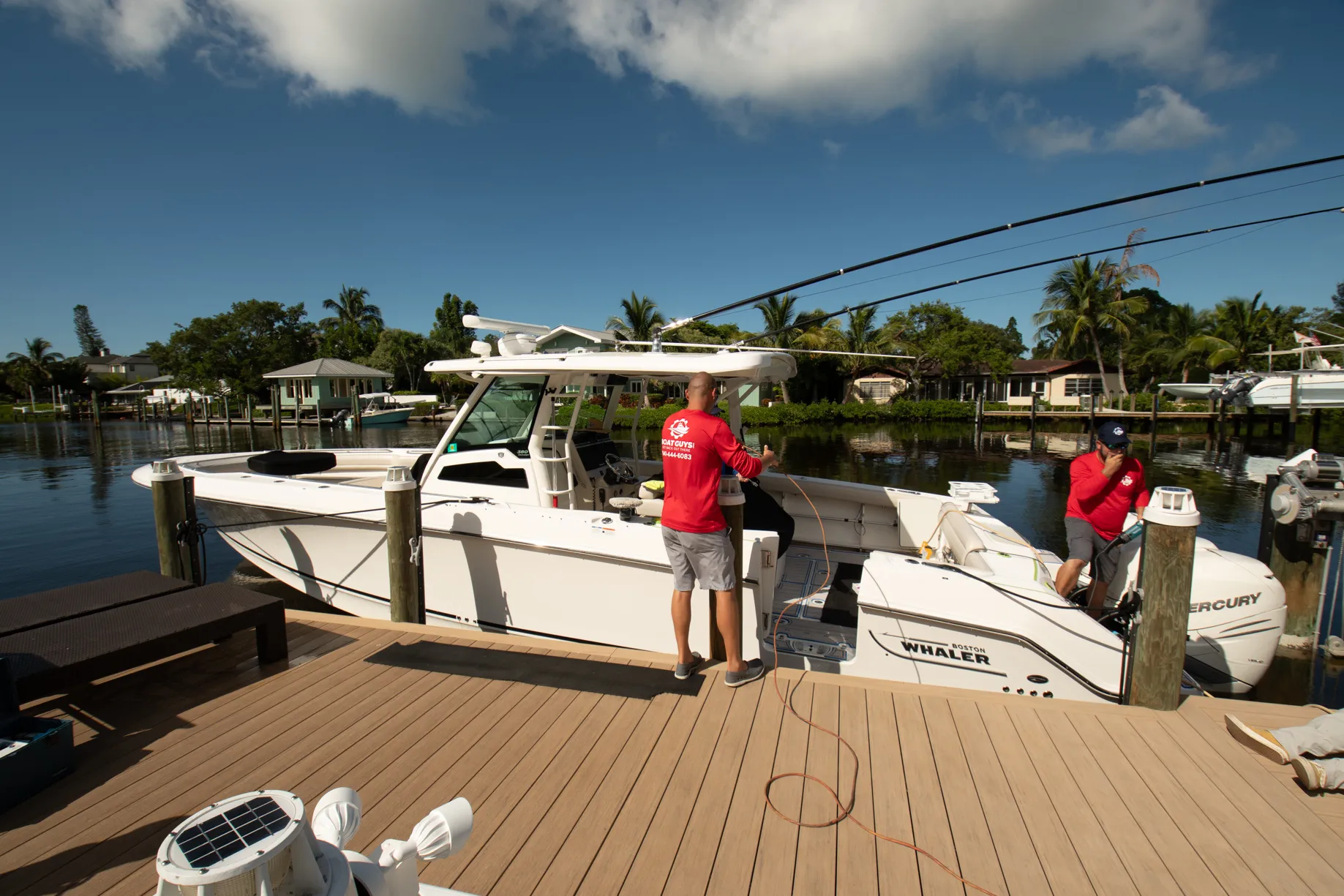 Boat Guys technicians working on a Boston Whaler at the dock