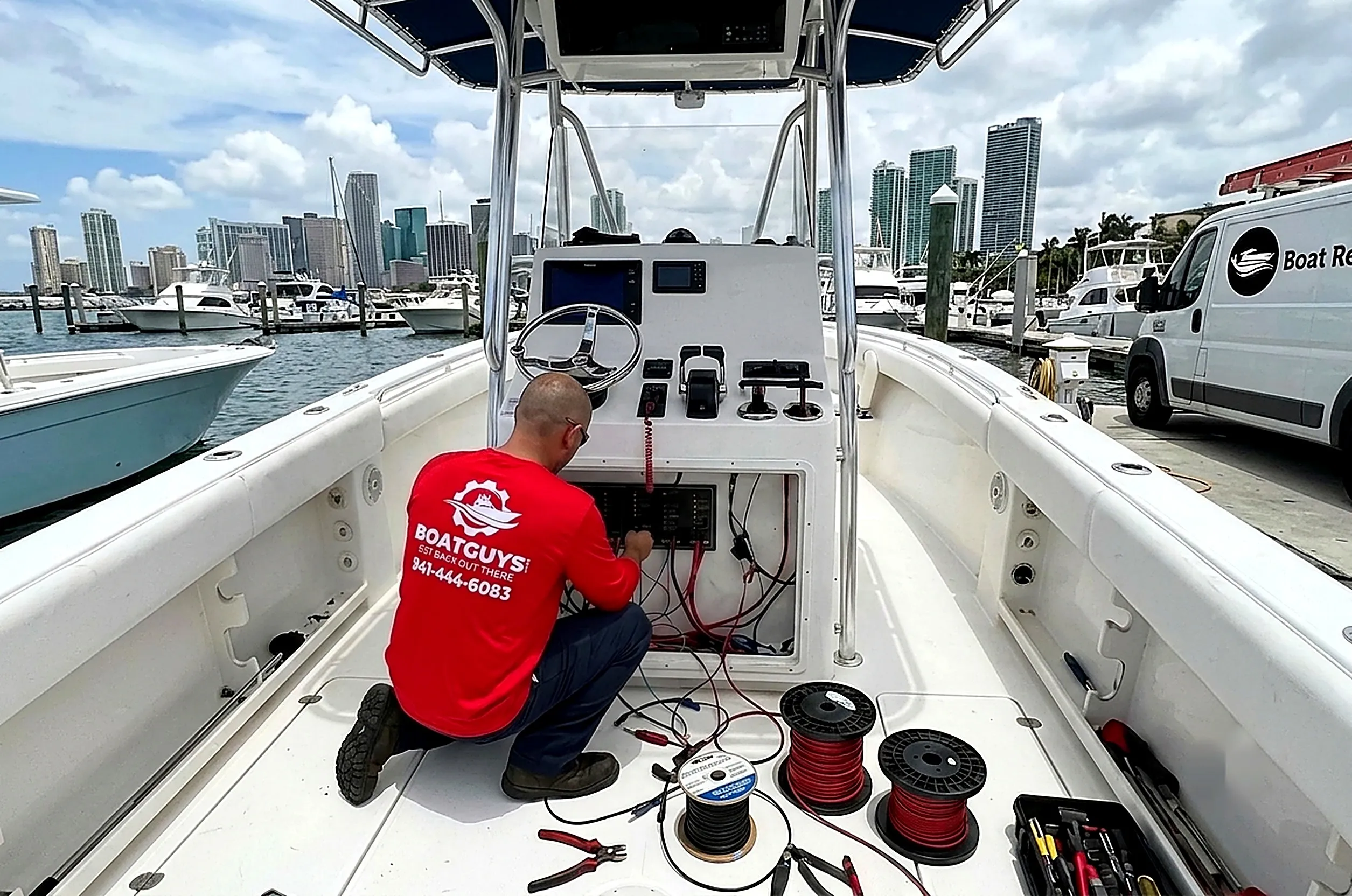 Boat Guys technician wiring a center-console helm at the dock