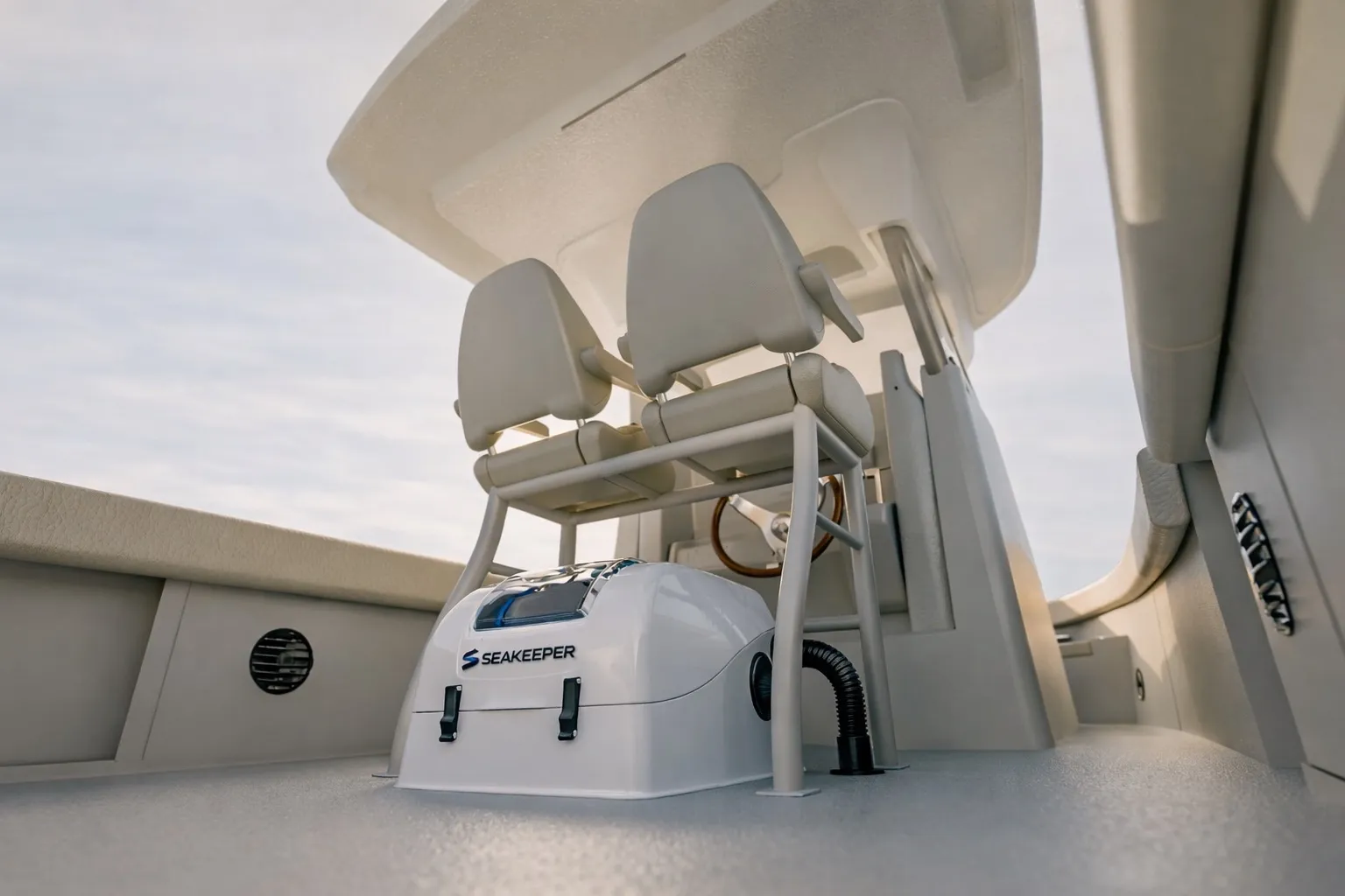 Seakeeper gyro stabilizer installed beneath the helm seats of a center-console boat